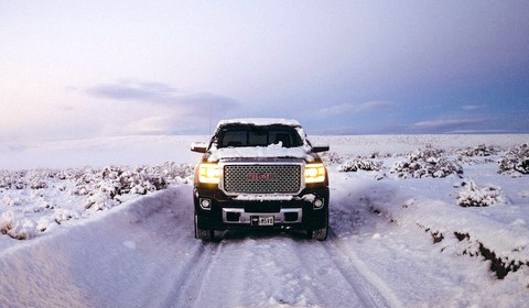 GMC Truck on a snowy road; Photo by Wesley Tingey on Unsplash