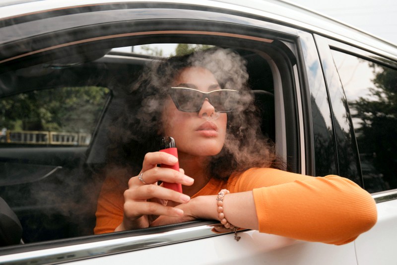 Smoking in car; Photo by Andrej Lisakov on Unsplash